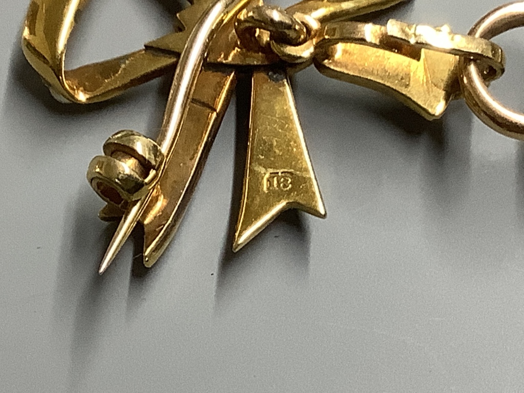 A lady's early 20th century yellow metal and seed pearl set fob watch, on a 18ct and seed pearl set bow brooch